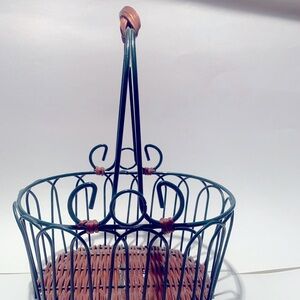 Green wire basket with brown woven bottom